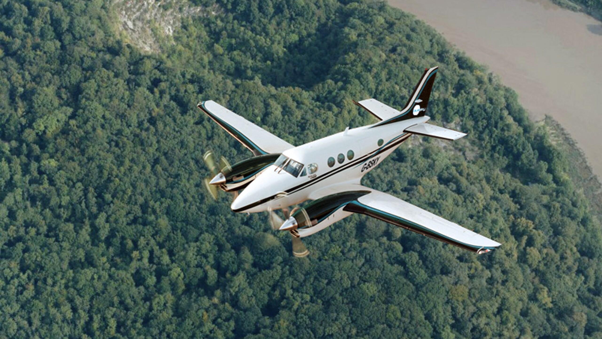 Aerial survey plane flying over a forest