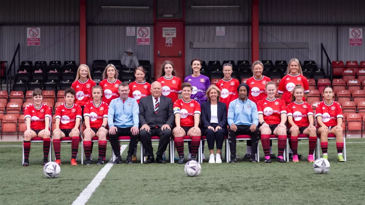 Tamworth Women's Football Team with Bluesky CEO Rachel Tidmarsh being photographed on the pitch