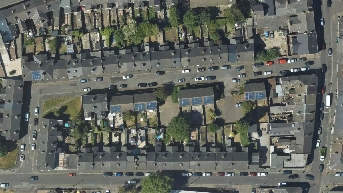 Aerial photograph of an urban street with solar panels on rooftops
